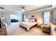 Spacious main bedroom with a tray ceiling, neutral decor, and access to a comfortable sitting area at 232 Hensley Hill Pl, Holly Springs, NC 27540