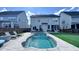 Beautiful backyard pool with stamped concrete patio and lounge chairs, perfect for relaxing and entertaining at 232 Hensley Hill Pl, Holly Springs, NC 27540