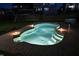 Night view of the backyard pool and patio, softly illuminated with exterior lights at 232 Hensley Hill Pl, Holly Springs, NC 27540