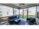 Cozy screened porch featuring comfortable seating, offering a relaxing outdoor living space with views of the backyard at 232 Hensley Hill Pl, Holly Springs, NC 27540