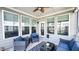 Cozy sunroom with ample windows and comfortable seating at 232 Hensley Hill Pl, Holly Springs, NC 27540