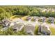 Scenic aerial view of a neighborhood with well-maintained homes and a tranquil pond surrounded by lush greenery at 3034 Raddercrest Ct, Fuquay Varina, NC 27526
