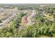 Birds-eye view of homes surrounded by mature landscaping and a tranquil pond, highlighting the neighborhood's charm at 3034 Raddercrest Ct, Fuquay Varina, NC 27526
