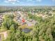 High-angle view of a neighborhood featuring lovely homes nestled among trees with a peaceful pond at 3034 Raddercrest Ct, Fuquay Varina, NC 27526