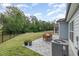 Backyard patio features a dining table on a gray stone patio and a large yard at 3034 Raddercrest Ct, Fuquay Varina, NC 27526