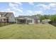Backyard view features a screened-in porch, patio, and dining table and great lawn at 3034 Raddercrest Ct, Fuquay Varina, NC 27526