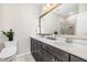 Modern bathroom features a double vanity, dark wood cabinets, white quartz countertop, and large mirror at 3034 Raddercrest Ct, Fuquay Varina, NC 27526