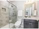 Bathroom features a tiled shower, glass doors, a vanity, and modern fixtures at 3034 Raddercrest Ct, Fuquay Varina, NC 27526