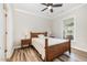 Comfortable bedroom features wood-look flooring, a ceiling fan, and a wooden bed frame at 3034 Raddercrest Ct, Fuquay Varina, NC 27526