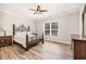 Bedroom with ceiling fan, wood-look flooring, large window, and traditional furniture at 3034 Raddercrest Ct, Fuquay Varina, NC 27526