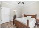 Cozy bedroom view features a glimpse of the ensuite bathroom and wood-look flooring at 3034 Raddercrest Ct, Fuquay Varina, NC 27526