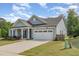 Beautiful single-story home with a two-car garage and well-maintained landscaping at 3034 Raddercrest Ct, Fuquay Varina, NC 27526