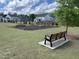 Community playground with benches, climbing structures, swings, and open green space for recreation at 3034 Raddercrest Ct, Fuquay Varina, NC 27526