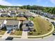 Aerial view of neighborhood and subject home with backyard, featuring a patio and fire pit at 325 Avery Glenn Way, Fuquay Varina, NC 27526