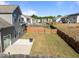 Aerial view of a fenced backyard with a patio and modern fire pit, providing an inviting outdoor space at 325 Avery Glenn Way, Fuquay Varina, NC 27526