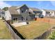 Spacious fenced backyard with a patio and fire pit, accessed through a sliding glass door from the home at 325 Avery Glenn Way, Fuquay Varina, NC 27526