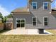 Inviting backyard featuring a modern fire pit, a concrete patio, and convenient access via sliding glass doors at 325 Avery Glenn Way, Fuquay Varina, NC 27526