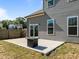 Cozy patio area with a fire pit, accessible via sliding glass doors, complements the fenced backyard at 325 Avery Glenn Way, Fuquay Varina, NC 27526