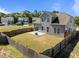 Expansive backyard with a wooden fence, patio area, and modern fire pit, offering privacy and charm at 325 Avery Glenn Way, Fuquay Varina, NC 27526