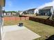 Large, fenced backyard featuring a patio and a modern fire pit, perfect for outdoor entertaining at 325 Avery Glenn Way, Fuquay Varina, NC 27526