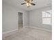 Neutral bedroom features a ceiling fan and closet at 325 Avery Glenn Way, Fuquay Varina, NC 27526