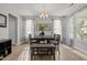 Bright dining room with a modern chandelier, natural light, and stylish decor for comfortable Gathering meals at 325 Avery Glenn Way, Fuquay Varina, NC 27526