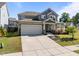 Charming two-story home featuring a gray facade, covered porch, two-car garage, and well-maintained landscaping at 325 Avery Glenn Way, Fuquay Varina, NC 27526