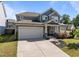 Charming two-story home featuring a gray facade, covered porch, two-car garage, and well-maintained landscaping at 325 Avery Glenn Way, Fuquay Varina, NC 27526