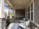 Inviting front porch with stone pillar bases, seating and a rug at 325 Avery Glenn Way, Fuquay Varina, NC 27526