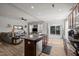 Open kitchen with island seating flows into a living area with backyard access, ideal for modern living at 325 Avery Glenn Way, Fuquay Varina, NC 27526