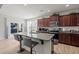 Open-concept kitchen with granite island, stainless appliances, and bar seating, perfect for casual dining at 325 Avery Glenn Way, Fuquay Varina, NC 27526