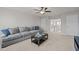 Comfortable living room with neutral carpet and a large gray sofa, offering plenty of space to relax at 325 Avery Glenn Way, Fuquay Varina, NC 27526