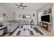 Comfortable living room with a plush gray sectional and a large window, perfect for relaxing or entertaining guests at 325 Avery Glenn Way, Fuquay Varina, NC 27526