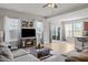 Spacious living room with large TV, sliding glass doors, and cozy sectional, perfect for entertaining and relaxation at 325 Avery Glenn Way, Fuquay Varina, NC 27526