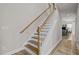 Stylish staircase with wood treads, white risers, and a stained wood handrail at 325 Avery Glenn Way, Fuquay Varina, NC 27526