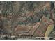 Aerial view showcasing land outline with surrounding nature and a road at 33 Versailles Ln, Pittsboro, NC 27312