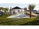 Community area featuring covered playground and picnic tables surrounded by lush landscaping at 348 Chesapeak Commons St # 137, Garner, NC 27529