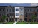 Charming townhome with a modern brick and siding exterior, complemented by green grass and landscaping at 364 Chesapeak Commons St # 133, Garner, NC 27529