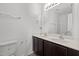 Bathroom with a double sink vanity and a large mirror at 3816 Mike Levi Ct, Raleigh, NC 27610