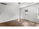 A sunny bedroom features luxury vinyl plank flooring, a window, and a white entry door at 3816 Mike Levi Ct, Raleigh, NC 27610