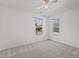 Carpeted bedroom with ceiling fan and windows offering neighborhood views at 3816 Mike Levi Ct, Raleigh, NC 27610