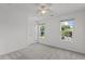 Carpeted bedroom with ceiling fan and windows offering outdoor views at 3816 Mike Levi Ct, Raleigh, NC 27610