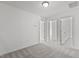 Bright, neutral bedroom featuring plush gray carpeting and multiple doorways at 3816 Mike Levi Ct, Raleigh, NC 27610
