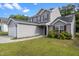 Well-maintained gray two-story home with a manicured lawn, and a two-car garage at 3816 Mike Levi Ct, Raleigh, NC 27610