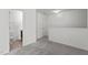 Hallway view featuring gray carpet, white trim, and bathroom access at 3816 Mike Levi Ct, Raleigh, NC 27610