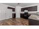 A kitchen is equipped with brown cabinets, laminate countertops, and luxury vinyl plank flooring at 3816 Mike Levi Ct, Raleigh, NC 27610