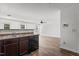 The open-concept kitchen features luxury vinyl plank flooring, an island sink, and stainless steel appliances at 3816 Mike Levi Ct, Raleigh, NC 27610