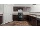 The kitchen is equipped with stainless steel appliances, brown cabinets, laminate countertops, and LVP flooring at 3816 Mike Levi Ct, Raleigh, NC 27610