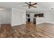 Open concept floor plan with wood floors, connecting the living room and kitchen area at 3816 Mike Levi Ct, Raleigh, NC 27610