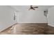 Bright living room featuring luxury vinyl plank flooring, ceiling fan, and natural light from the window at 3816 Mike Levi Ct, Raleigh, NC 27610
